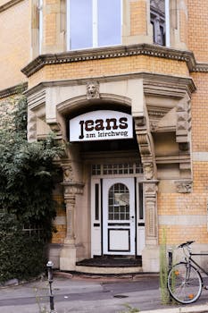 A vintage style jeans shop entrance in Kassel, Germany, showcasing unique architectural details.