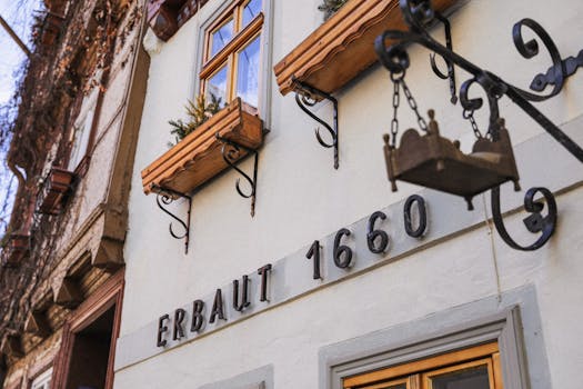 Close-up of a historic building facade with 'Erbaut 1660' text and decorative elements.